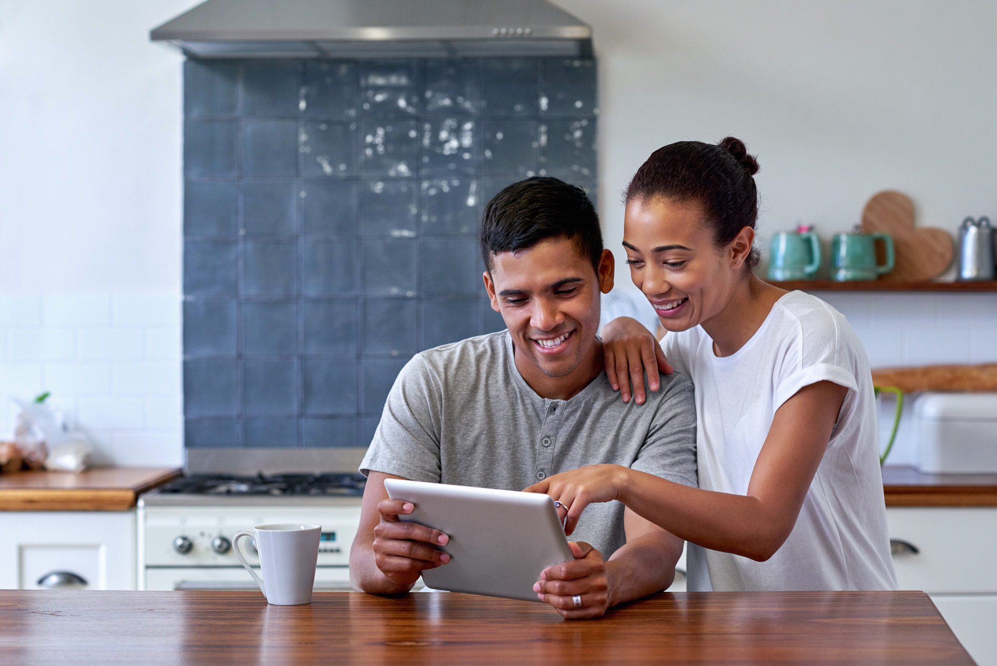 young happy couple on a tablet in the kitchen 